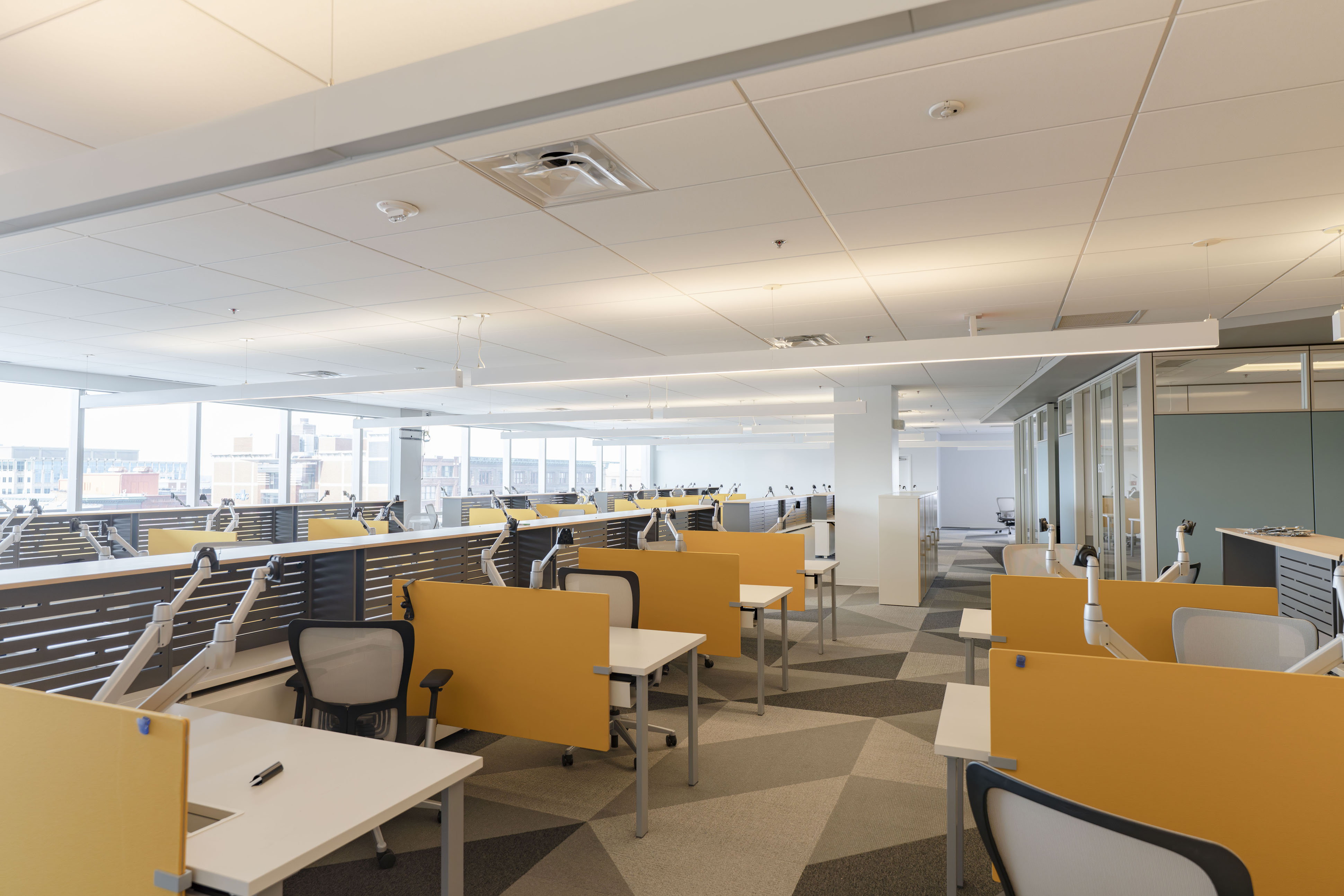 Centennial Building 8th floor tower office with modern furniture, gold dividers, and natural light